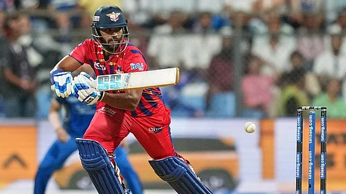 Photo: AP : Nicholas Pooran plays a shot during the Indian Premier League match between Mumbai Indians and Lucknow Super Giants in Mumbai.