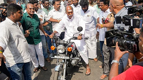 | Photo: PTI/R Senthilkumar : Puducherry Chief Minister N Rangasamy leaves on a motorcycle after casting vote during the Puducherry Assembly elections, at a polling station in Puducherry.