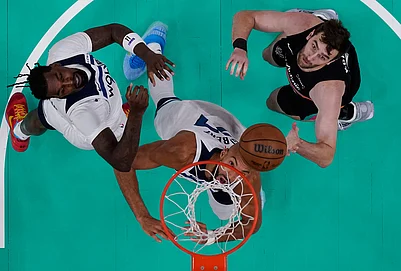 | Photo: AP/Eric Gay : Minnesota Timberwolves center Naz Reid, left, center Rudy Gobert, center, and San Antonio Spurs center Luke Kornet, right, eye a rebound during the first half in Game 1 of a second-round NBA playoffs basketball series in San Antonio.