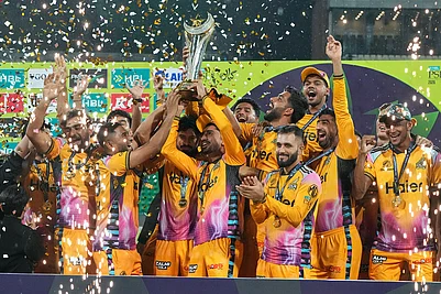 Photo: AP/K.M. Chaudary : Players of Peshawar Zalmi celebrates as they pose for photo with trophy after winning the Pakistan Super League final cricket match against Hyderabad Kingsmen, in Lahore, Pakistan.