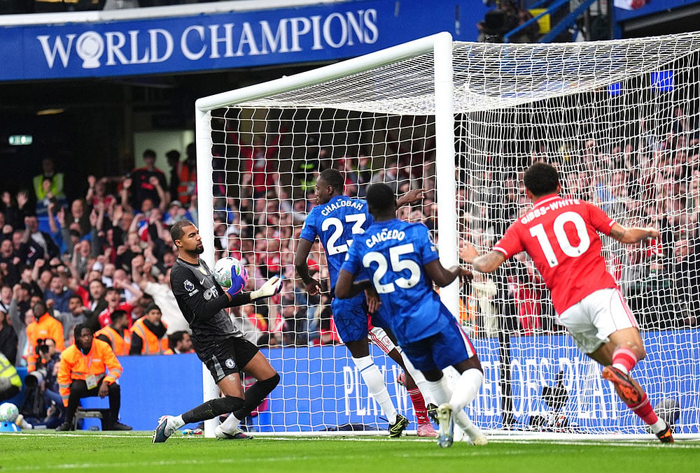| Photo: John Walton/PA via AP : Chelsea goalkeeper Robert Sanchez, left, reacts after Nottingham Forests Taiwo Awoniyi, center obscured, scores their sides third goal of the game during the English Premier League soccer match between Chelsea and Nottingham Forest in London.