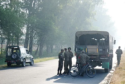 | Photo: PTI/Shiva Sharma : Security personnel remain deployed near the blast site close to the Army cantonment area at Khasa, in Amritsar district. Preliminary investigation suggested that an object was hurled towards the boundary wall, triggering the blast, police said.