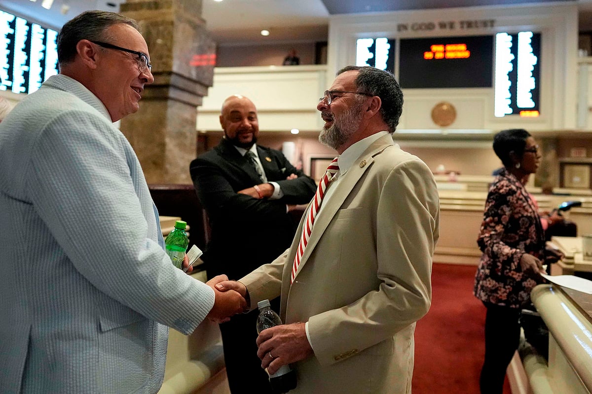 PTI : Republican state Rep. Chris Pringle, centre, speaks to a colleague on the House floor during a special session of the Alabama Legislature.